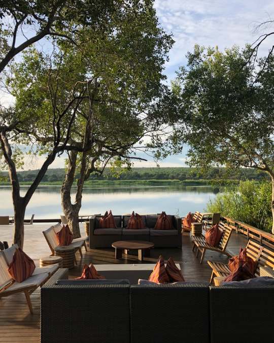 Nanan Travel - Balancing Luxury & Wilderness in African Safaris Ultimate Guide- Elephants at pool at lodge in Africa